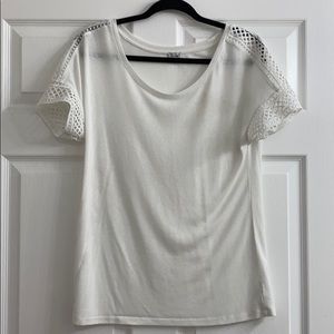 White t-shirt with lace trim.
